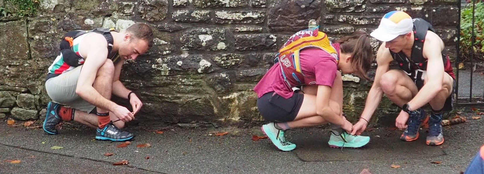 Runners tying up shoes