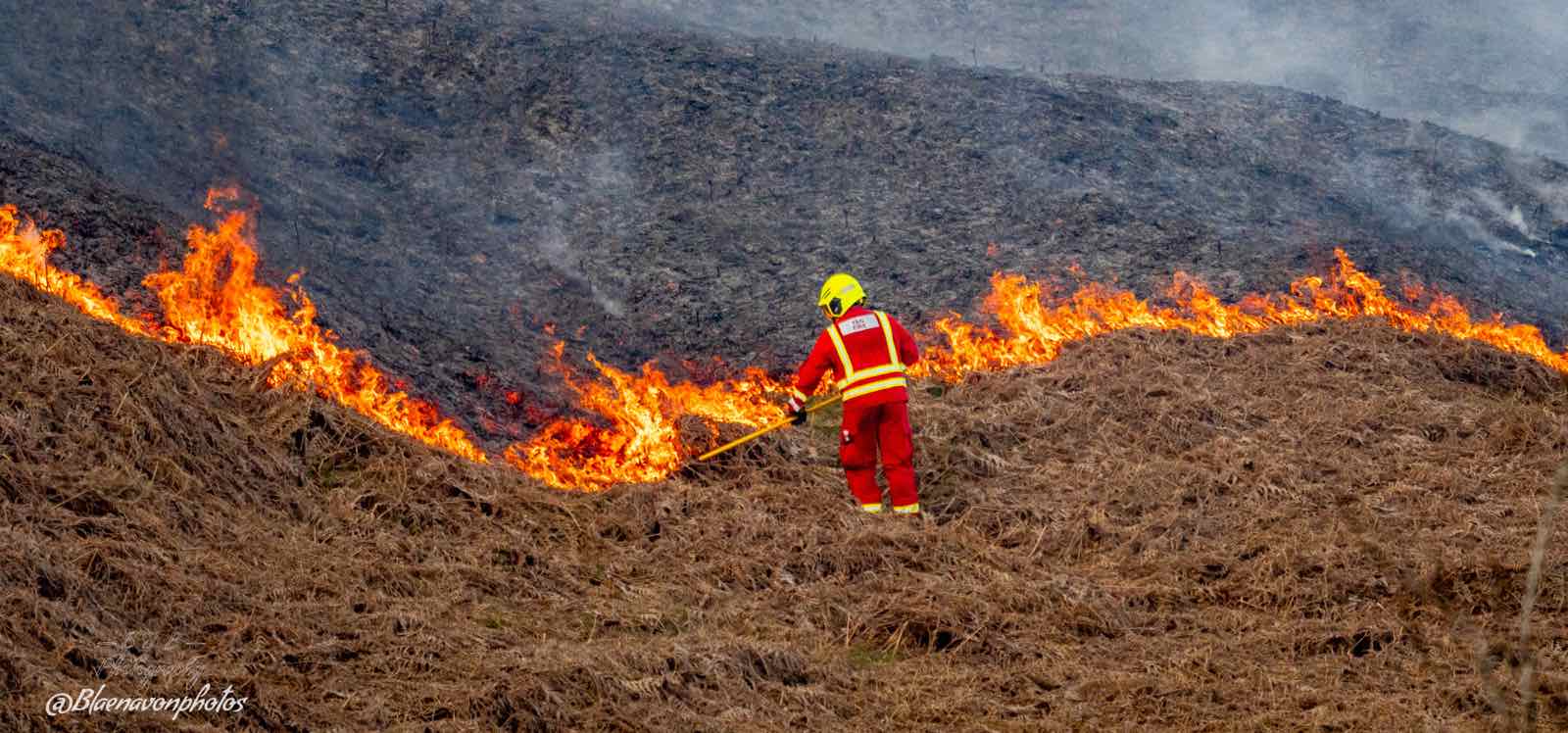 A firefighter tackling wildfire on the Blorenge